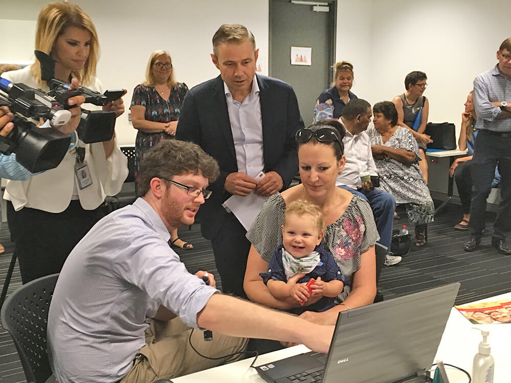 Dr Chris Brennan-Jones from the Telethon Kids Ear Health Team, talks to Health  Minister Roger Cook and the Castle family about the new research project. 