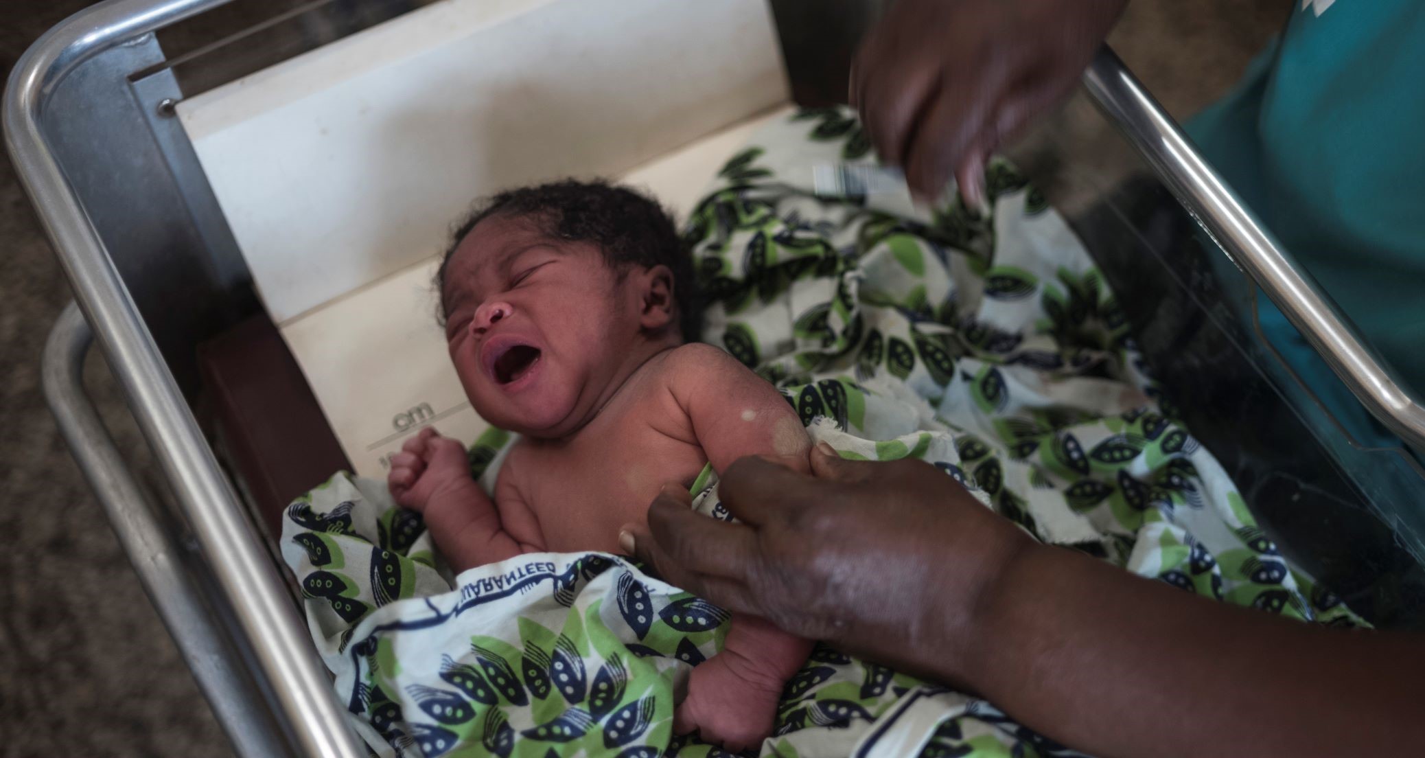 Baby in Guinea Bissau receiving vaccination