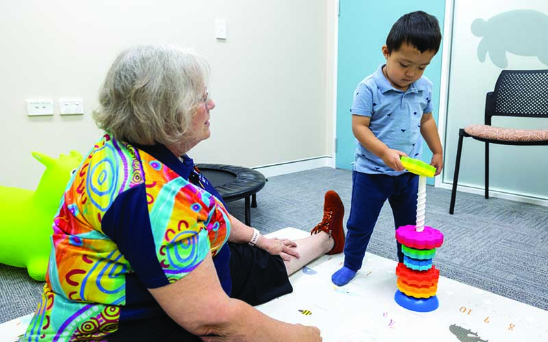 Tate Roberts and CliniKids Senior Occupational Therapist Gayle Hillen in a CliniKids office